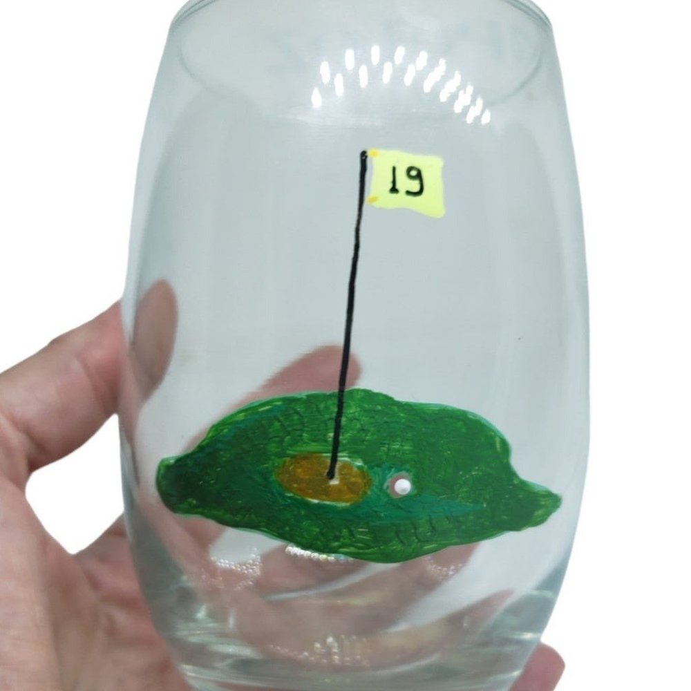 Handpainted wine glass stem less " 19 th hole" golf theme